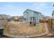 Large backyard featuring a play set, swing set, fence, patio and a well manicured lawn at 2080 S Danube Ct, Aurora, CO 80013