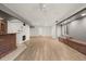Spacious basement with light walls, hardwood floors and brick accents near a window and wall at 2080 S Danube Ct, Aurora, CO 80013
