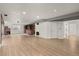 Spacious finished basement with light floors, neutral paint, fireplace, and access to rooms at 2080 S Danube Ct, Aurora, CO 80013