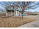 Two-story home with blue siding and two-car garage on a corner lot with a mature tree at 2080 S Danube Ct, Aurora, CO 80013
