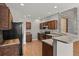 Kitchen with wooden cabinets, stainless steel appliances, light walls and a concrete breakfast bar at 2080 S Danube Ct, Aurora, CO 80013