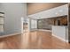 Bright living room with wood floors, tall ceilings and a wood accent wall with open access to the kitchen at 2080 S Danube Ct, Aurora, CO 80013