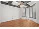Bright room with hardwood floors, modern light fixture, and stylish ceiling beams at 2080 S Danube Ct, Aurora, CO 80013