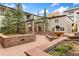 Charming courtyard with stone benches, manicured landscaping, pergola, and tranquil fountain at 2800 Aurora Ave # 118, Boulder, CO 80303