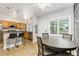 Bright kitchen and dining area with wooden cabinets, granite countertops, and natural light at 2800 Aurora Ave # 118, Boulder, CO 80303