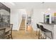 Inviting open-concept living room featuring a staircase, kitchen bar, and unique chalkboard wall at 2800 Aurora Ave # 118, Boulder, CO 80303