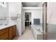 Bright bathroom features a soaking tub, glass shower, and vanity with wood cabinets at 9567 Brentwood Way # A, Broomfield, CO 80021