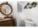 Powder room features a marble countertop, bronze faucet, and an ornate gold mirror at 9567 Brentwood Way # A, Broomfield, CO 80021