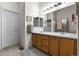 Primary bathroom features a double sink vanity with wood cabinets and modern lighting fixtures at 9567 Brentwood Way # A, Broomfield, CO 80021
