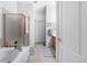 Bathroom features a bathtub with a glass shower enclosure and a door leading to the hallway at 9567 Brentwood Way # A, Broomfield, CO 80021