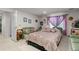 A well-lit room with a comfortable bed, seating area, and decorative accessories at 9567 Brentwood Way # A, Broomfield, CO 80021