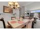 Charming dining area featuring a chandelier, table setting, and access to the living room at 9567 Brentwood Way # A, Broomfield, CO 80021