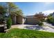 Lovely single-story home featuring a well-maintained lawn, a two-car garage, and mature trees at 9567 Brentwood Way # A, Broomfield, CO 80021