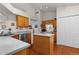 Bright eat-in kitchen features wood cabinets, an island, and updated appliances at 9567 Brentwood Way # A, Broomfield, CO 80021