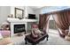Comfortable living room with a fireplace, a large window, and elegant decor at 9567 Brentwood Way # A, Broomfield, CO 80021