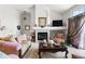 Bright living room with fireplace, large window, neutral decor, and comfortable seating at 9567 Brentwood Way # A, Broomfield, CO 80021