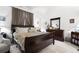 Main bedroom features a large bed, neutral carpet, and a large dresser with a mirror at 9567 Brentwood Way # A, Broomfield, CO 80021