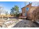 Backyard features a wooden deck, hot tub, and mature trees under a clear blue sky at 2541 Yarmouth Ave, Boulder, CO 80301