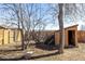 Backyard includes a storage shed, trees, wooden fence, and a bench at 2541 Yarmouth Ave, Boulder, CO 80301