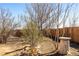 Backyard showing dry grass, a wooden fence, and mature trees under a clear sky at 2541 Yarmouth Ave, Boulder, CO 80301