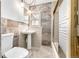 Bathroom featuring a pedestal sink, ceramic tiling, and a shower at 2541 Yarmouth Ave, Boulder, CO 80301