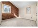 Bright bedroom showcases two windows, cozy carpet, and a stylish wood accent wall at 2541 Yarmouth Ave, Boulder, CO 80301