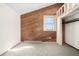 Bedroom with accent wall featuring horizontal wooden planks and large window overlooking the yard at 2541 Yarmouth Ave, Boulder, CO 80301