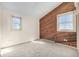 Sun-filled bedroom offers cozy carpet and a wood accent wall with a window at 2541 Yarmouth Ave, Boulder, CO 80301