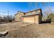 View of the home's exterior, highlighting the large garage and ample yard space at 2541 Yarmouth Ave, Boulder, CO 80301