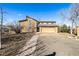 View of the home's exterior, featuring an oversized garage and unique roofline design at 2541 Yarmouth Ave, Boulder, CO 80301