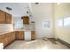 Unrenovated kitchen space with natural light, tile flooring, and cabinets at 2541 Yarmouth Ave, Boulder, CO 80301