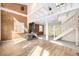 Open living room with wood floors, featuring a stone fireplace and an adjacent staircase at 2541 Yarmouth Ave, Boulder, CO 80301