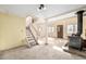 Bright living room with a wood burning stove, carpeted floors, and a staircase to the second level at 2541 Yarmouth Ave, Boulder, CO 80301