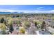 A stunning aerial view that highlights the property's location in a lush, green neighborhood with mountain views at 505 S Roosevelt Rd, Lafayette, CO 80026