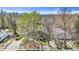 A beautiful aerial view of the house featuring a mature tree-lined yard, a driveway, and a walkway at 505 S Roosevelt Rd, Lafayette, CO 80026