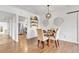 Dining area featuring modern light fixture and decorative wall art, open to kitchen at 505 S Roosevelt Rd, Lafayette, CO 80026