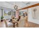 Bright dining room with hardwood floors, wood beam accents, and modern light fixture at 505 S Roosevelt Rd, Lafayette, CO 80026