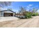 View of the side garage with concrete driveway and flowers at 505 S Roosevelt Rd, Lafayette, CO 80026