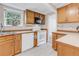 Functional kitchen with wooden cabinetry and a window overlooking the yard at 505 S Roosevelt Rd, Lafayette, CO 80026