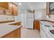 Cozy kitchenette featuring wooden cabinets, white appliances, and ample counter space at 505 S Roosevelt Rd, Lafayette, CO 80026