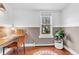 Bright home office with a large window, wood floors, and stylish decor, creating a productive workspace at 505 S Roosevelt Rd, Lafayette, CO 80026