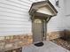 Inviting condo entryway with stone accents and a covered porch at 10381 Cook Way # 205, Thornton, CO 80229