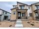 Charming townhome with stone accents, covered porch, and well-maintained gravel landscaping at 6668 N Nepal Ct, Aurora, CO 80019