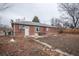 The backyard view shows the brick home with a patio area at 840 Tucson St, Aurora, CO 80011