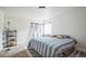 Bedroom featuring a bed, carpeted floors, a window with curtains, and a floor lamp at 840 Tucson St, Aurora, CO 80011