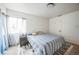 Bedroom featuring a bed, carpeted floors, a window with curtains, and a bedside table at 840 Tucson St, Aurora, CO 80011