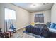 This cozy bedroom features wood floors, and large windows with curtains at 840 Tucson St, Aurora, CO 80011