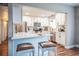 View of updated kitchen and bar with quartz countertop at 840 Tucson St, Aurora, CO 80011