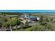 Aerial view of modern home with mature trees, landscaping, and driveway at 1175 Ridge Oaks Dr, Castle Rock, CO 80104