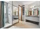 Modern bathroom with gray tile shower, dual sinks and mirrors, and separate closet at 1175 Ridge Oaks Dr, Castle Rock, CO 80104